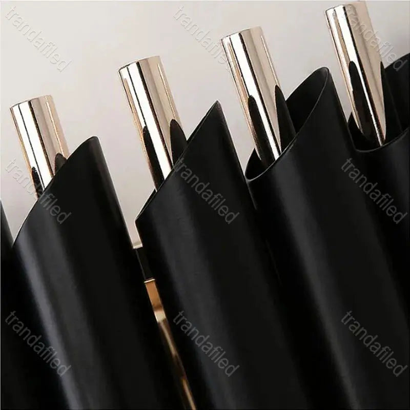 black-and-gold-wall-sconce-with-clear-crystal-pendants-turned-on-mounted-on-wall-elegant-modern-indoor-lighting